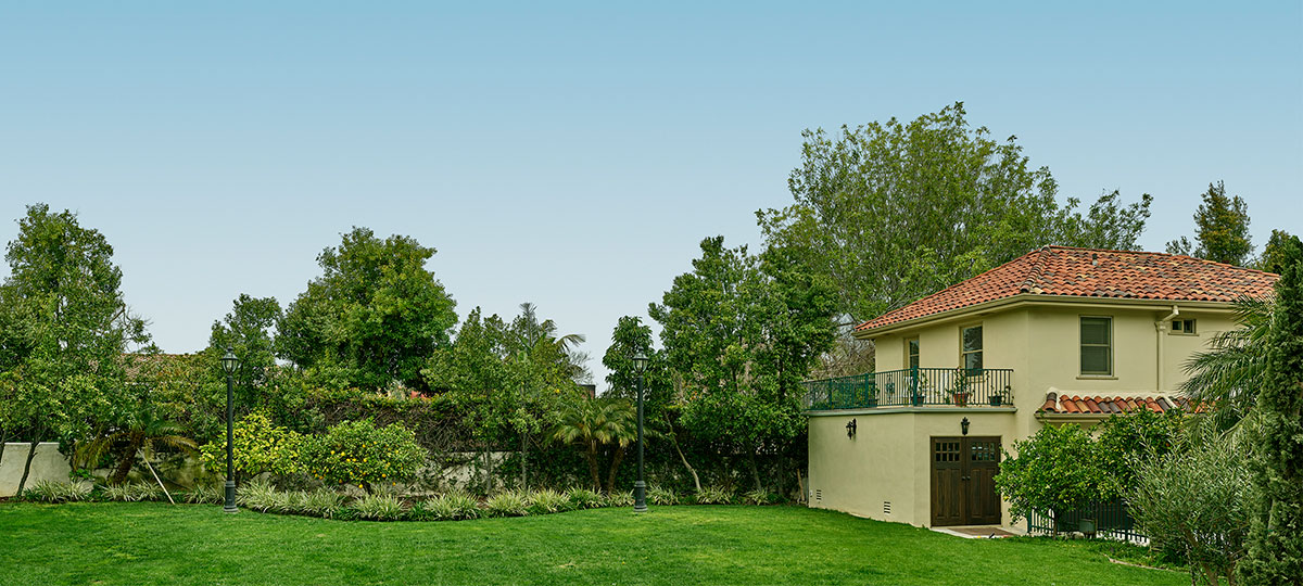 Stock Photo Night view of residential backyard with guest house